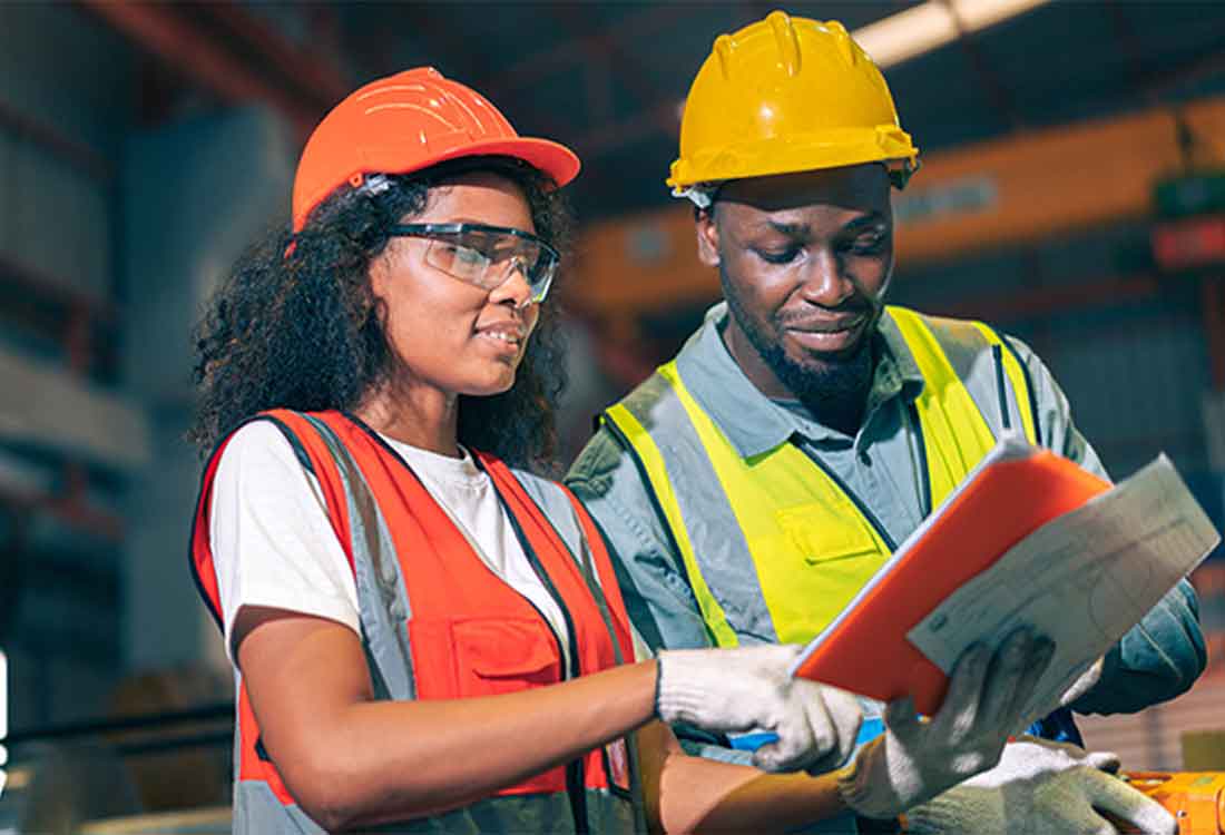 Construction workers reviewing safety documents together
