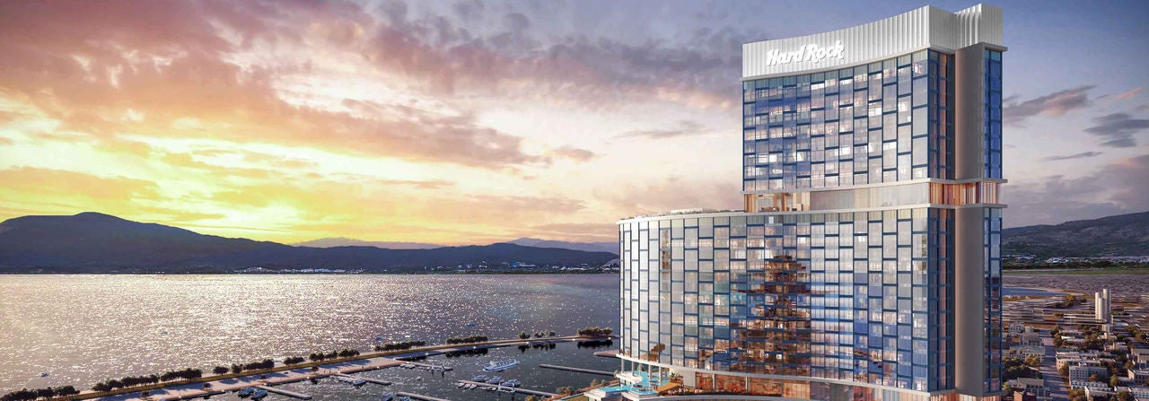Modern waterfront hotel tower at sunset