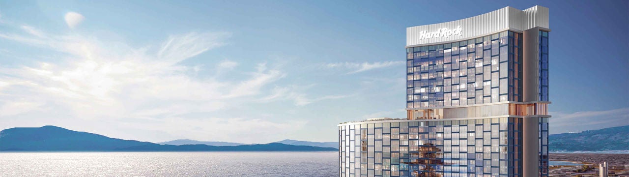 Modern waterfront hotel tower at sunrise