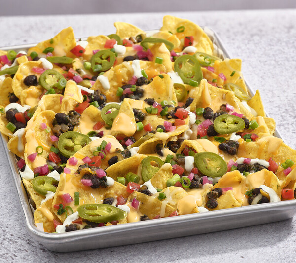 LEGENDARY NACHOS a tray of nachos with jalapenos and cheese