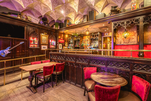 a room with a bar and chairs