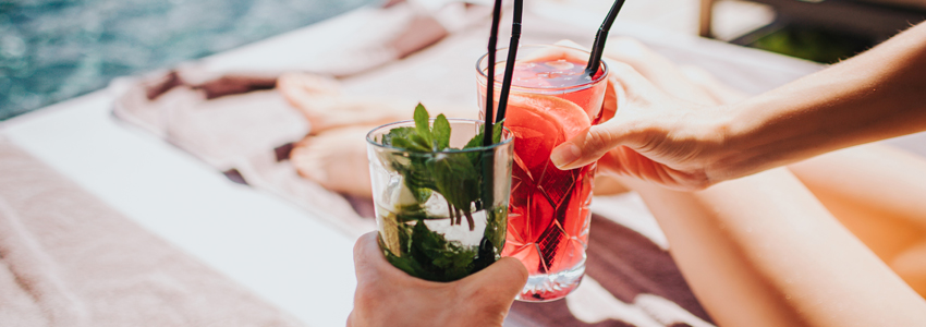 a pair of hands holding drinks