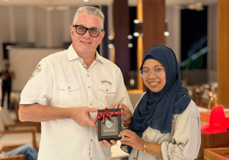 a man and woman holding a black box